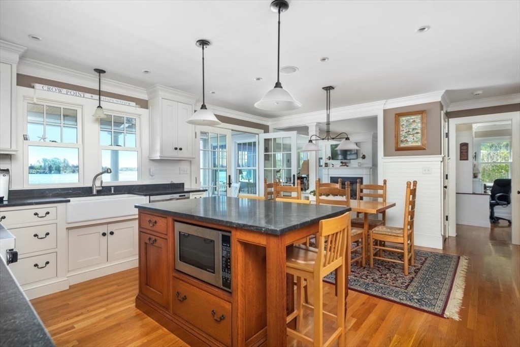 187 Downer Avenue Hingham, MA 02043 - Photo 11 of 42 a kitchen with stainless steel appliances granite countertop a stove a sink and a wooden floor
