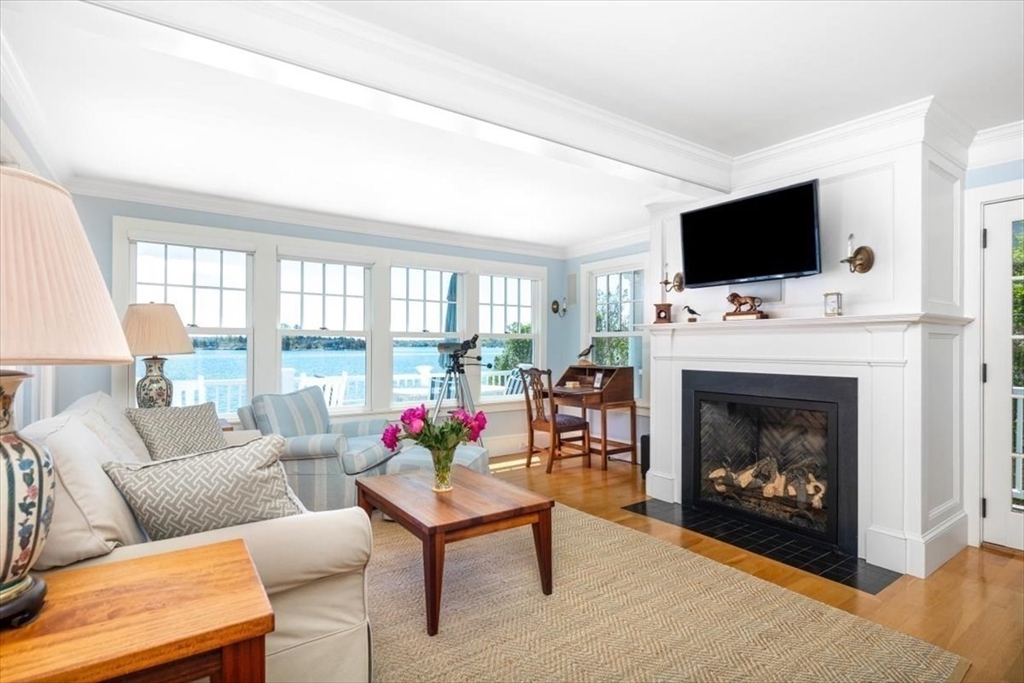 187 Downer Avenue Hingham, MA 02043 - Photo 23 of 42 a living room with furniture a flat screen tv and a fireplace
