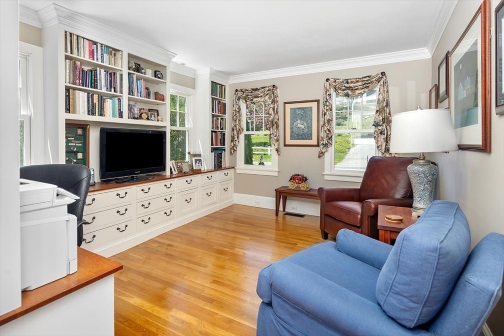 187 Downer Avenue Hingham, MA 02043 - Photo 25 of 42 a living room with furniture bookshelf and a flat screen tv