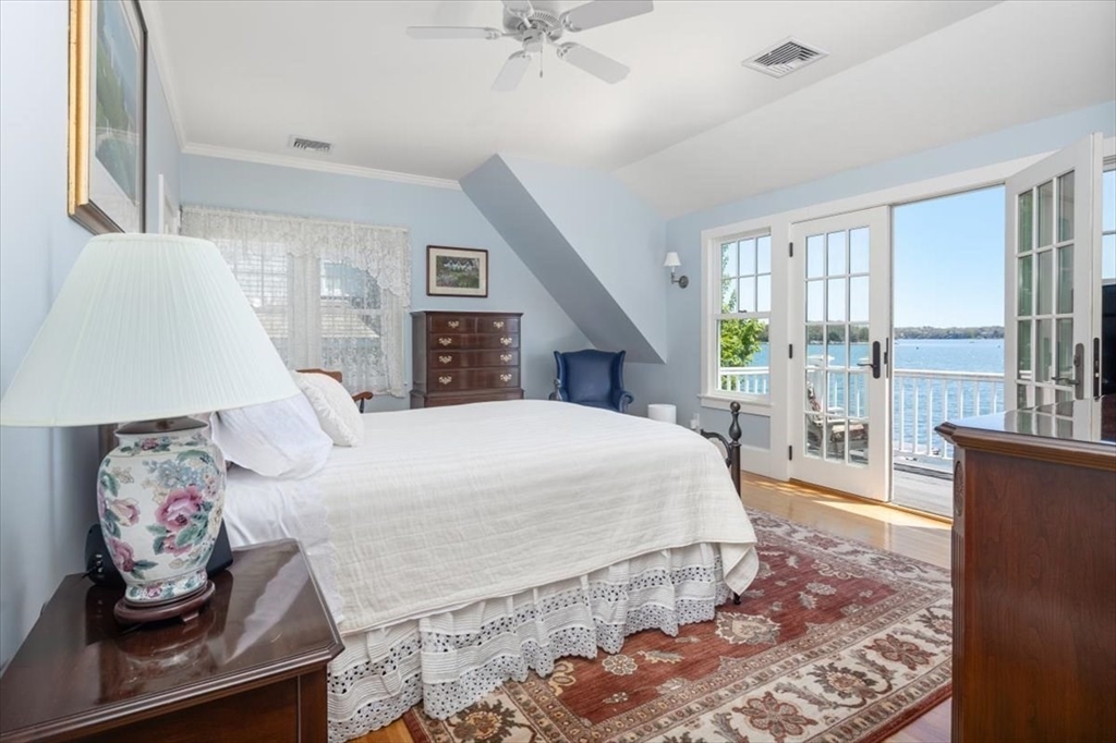 187 Downer Avenue Hingham, MA 02043 - Photo 28 of 42 a spacious bedroom with a large bed and a window