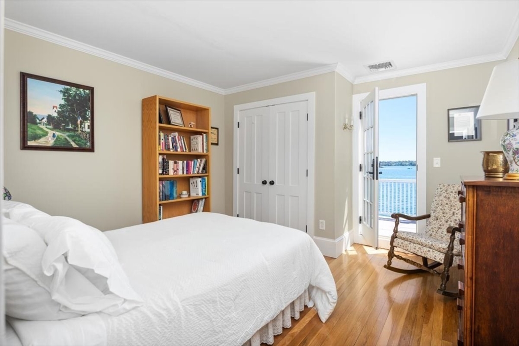 187 Downer Avenue Hingham, MA 02043 - Photo 31 of 42 a bedroom with a bed and a book shelf