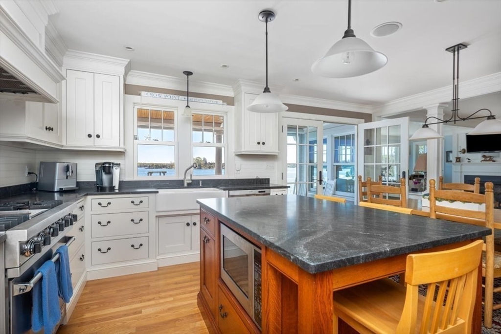 187 Downer Avenue Hingham, MA 02043 - Photo 7 of 42 a kitchen with stainless steel appliances granite countertop microwave stove top oven and cabinets