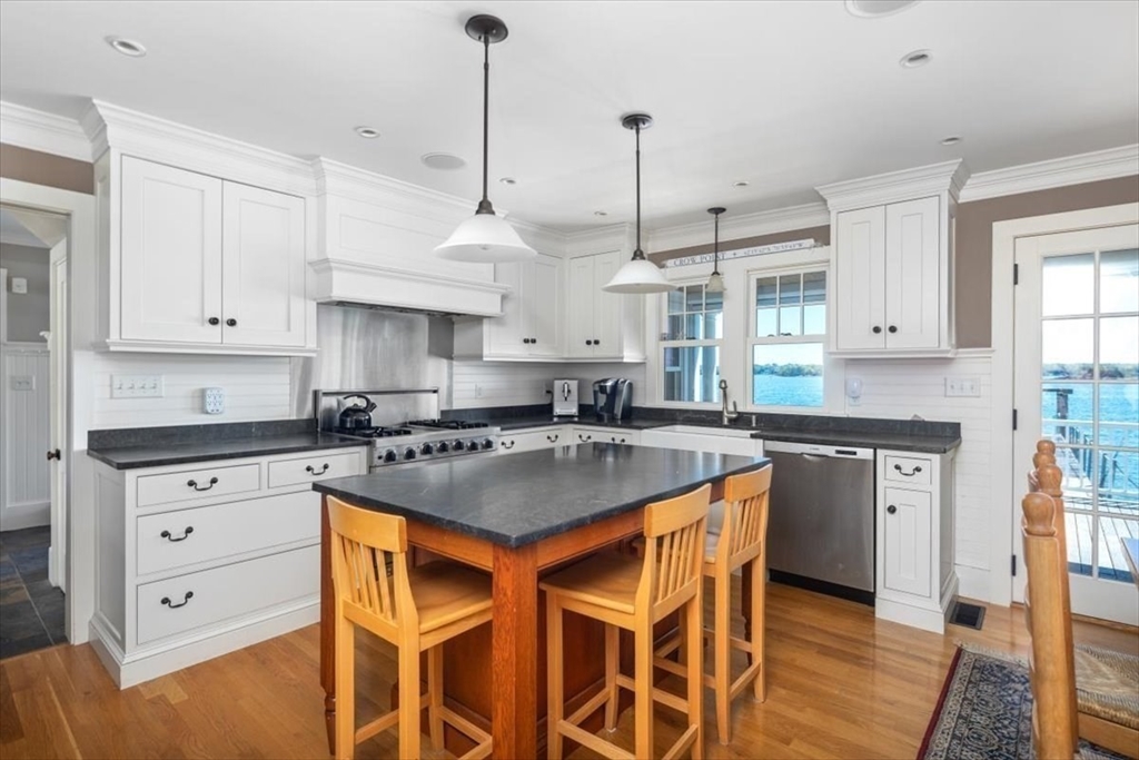 187 Downer Avenue Hingham, MA 02043 - Photo 10 of 42 a kitchen with stainless steel appliances granite countertop a stove a sink dishwasher and a refrigerator with white cabinets