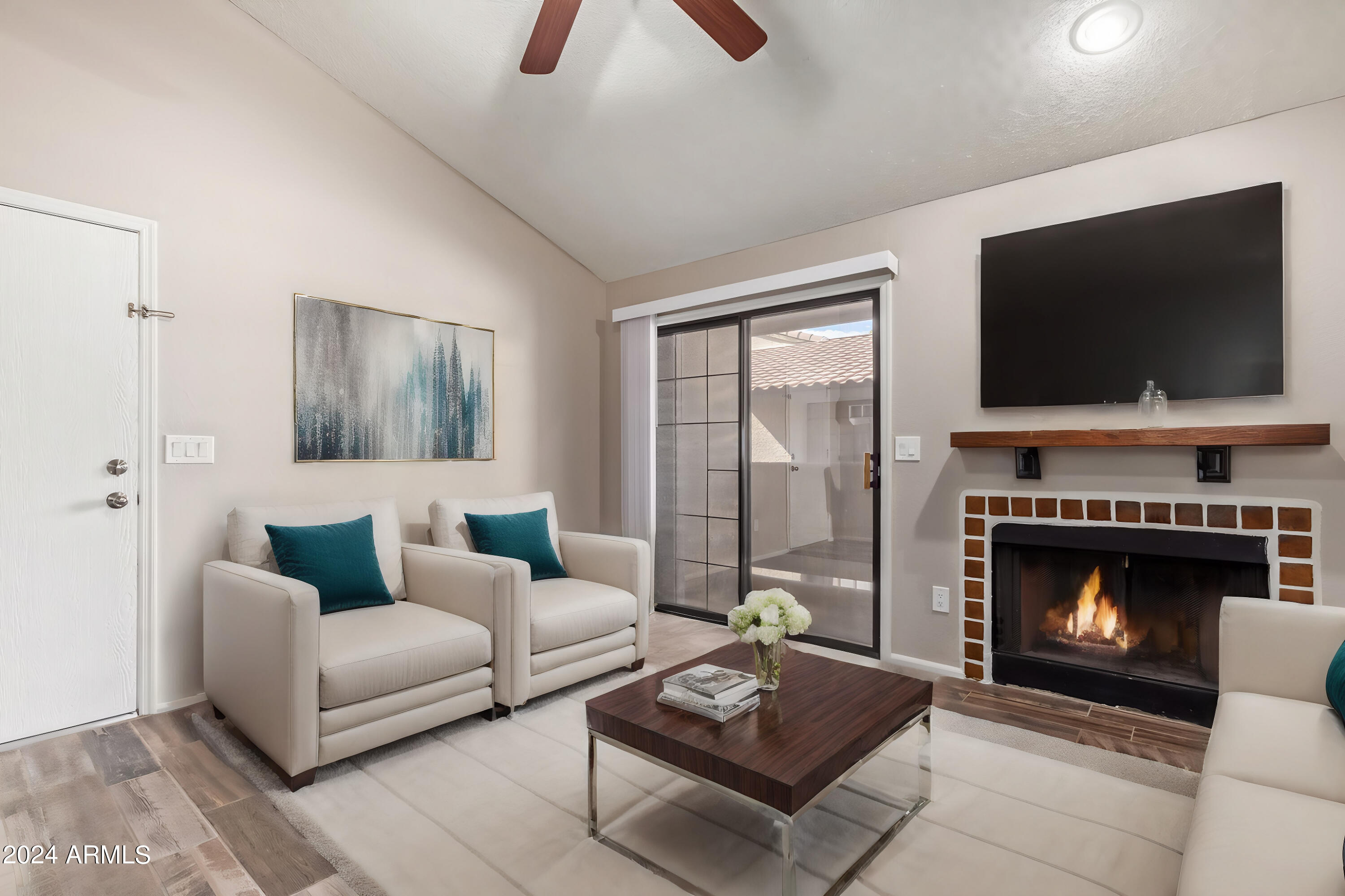 533 West Guadalupe Road, Unit 2046 Mesa, AZ 85210 - Photo 2 of 29 a living room with furniture a flat screen tv and a fireplace