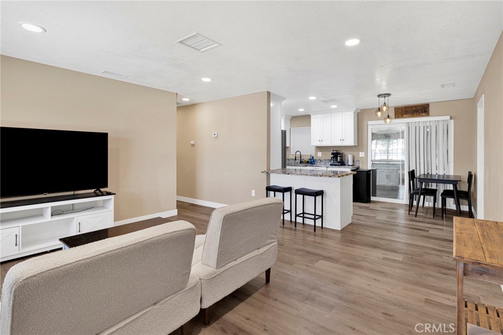 15471 Washoan Road Apple Valley, CA 92307 - Photo 9 of 38 a living room with stainless steel appliances furniture and a flat screen tv