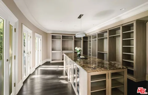 a view of a kitchen with a sink and cabinets