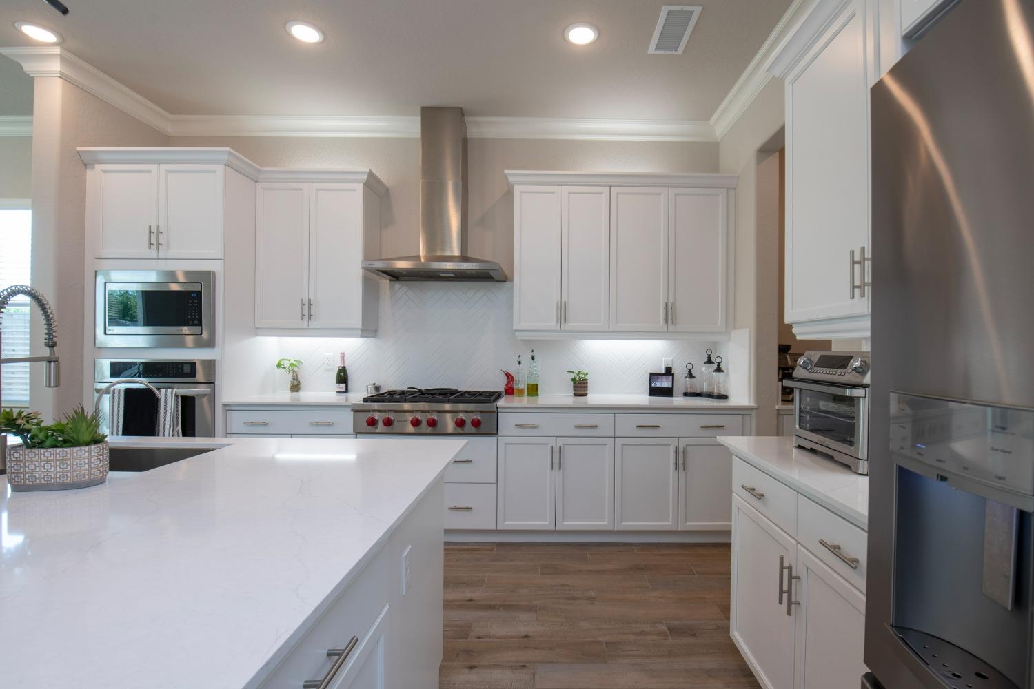 2120 North Perry Avenue Clovis, CA 93619 - Photo 12 of 37 a kitchen with cabinets stainless steel appliances and a counter space