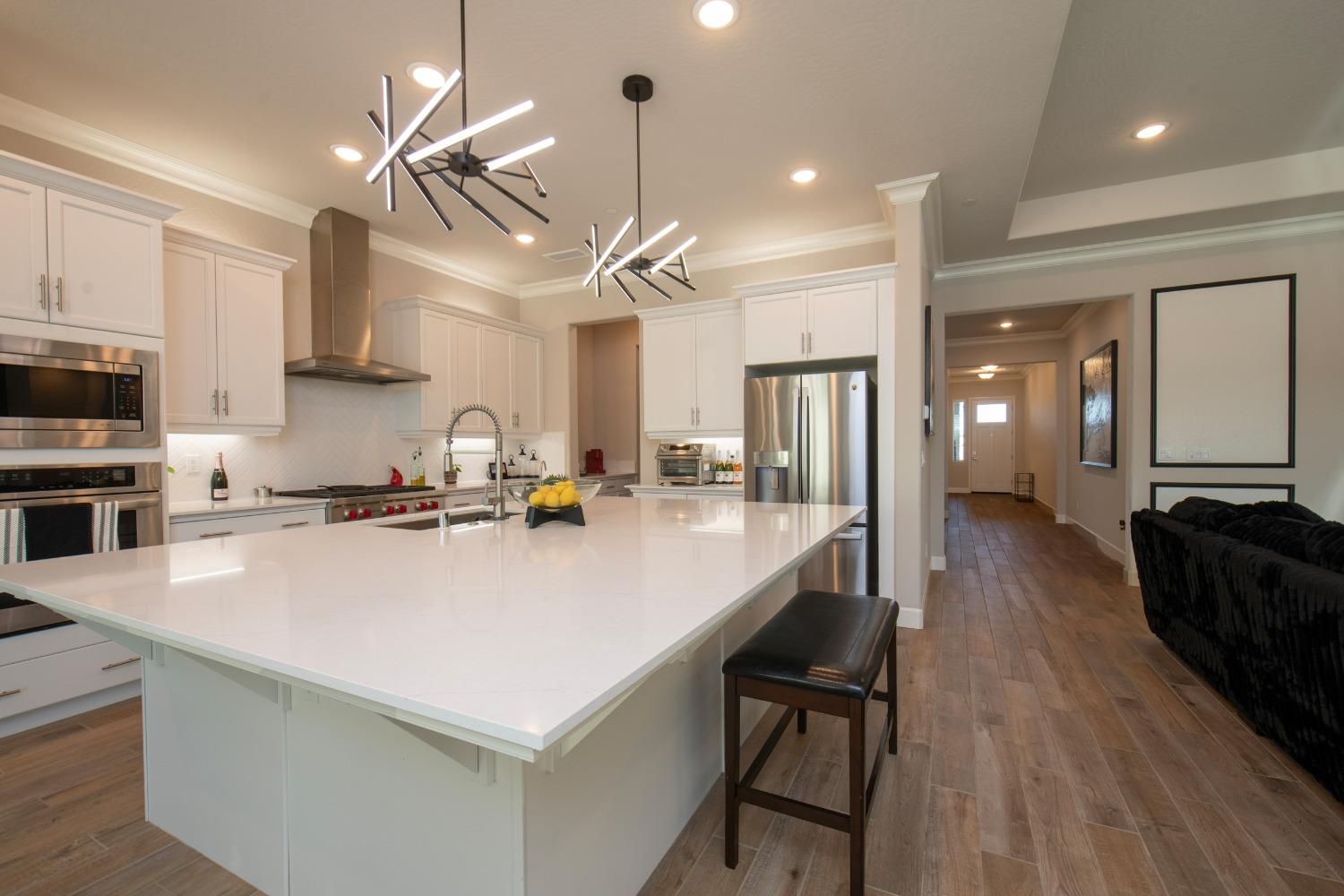 2120 North Perry Avenue Clovis, CA 93619 - Photo 13 of 37 a kitchen with a sink a counter top space stainless steel appliances and cabinets