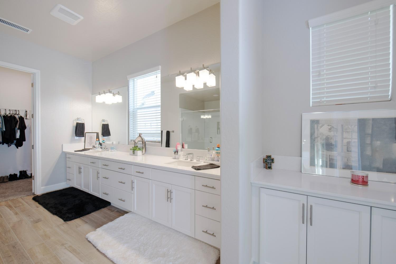 2120 North Perry Avenue Clovis, CA 93619 - Photo 22 of 37 a spacious bathroom with a granite countertop sink a toilet and a mirror