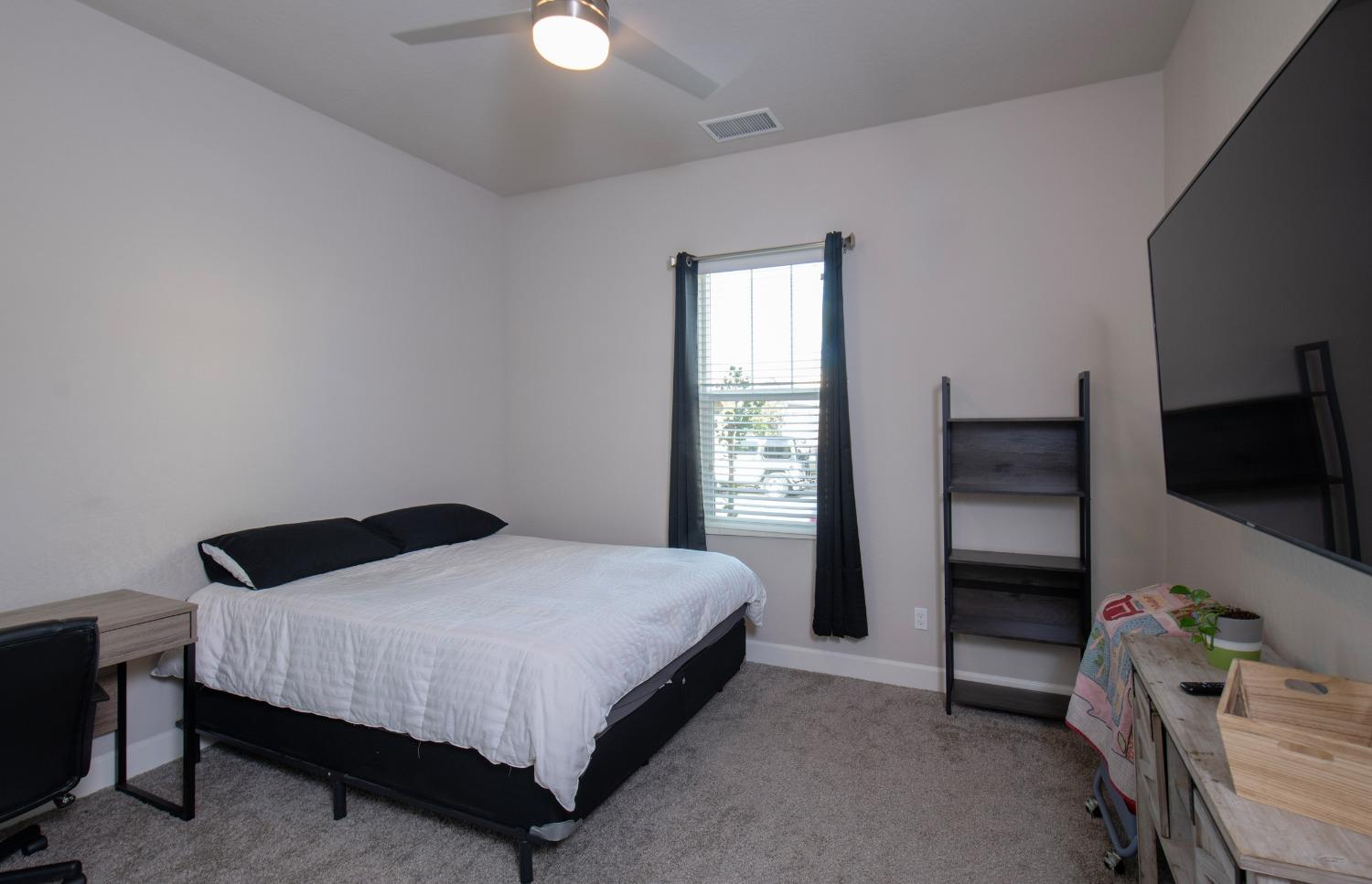 2120 North Perry Avenue Clovis, CA 93619 - Photo 24 of 37 a bedroom with a bed and a window