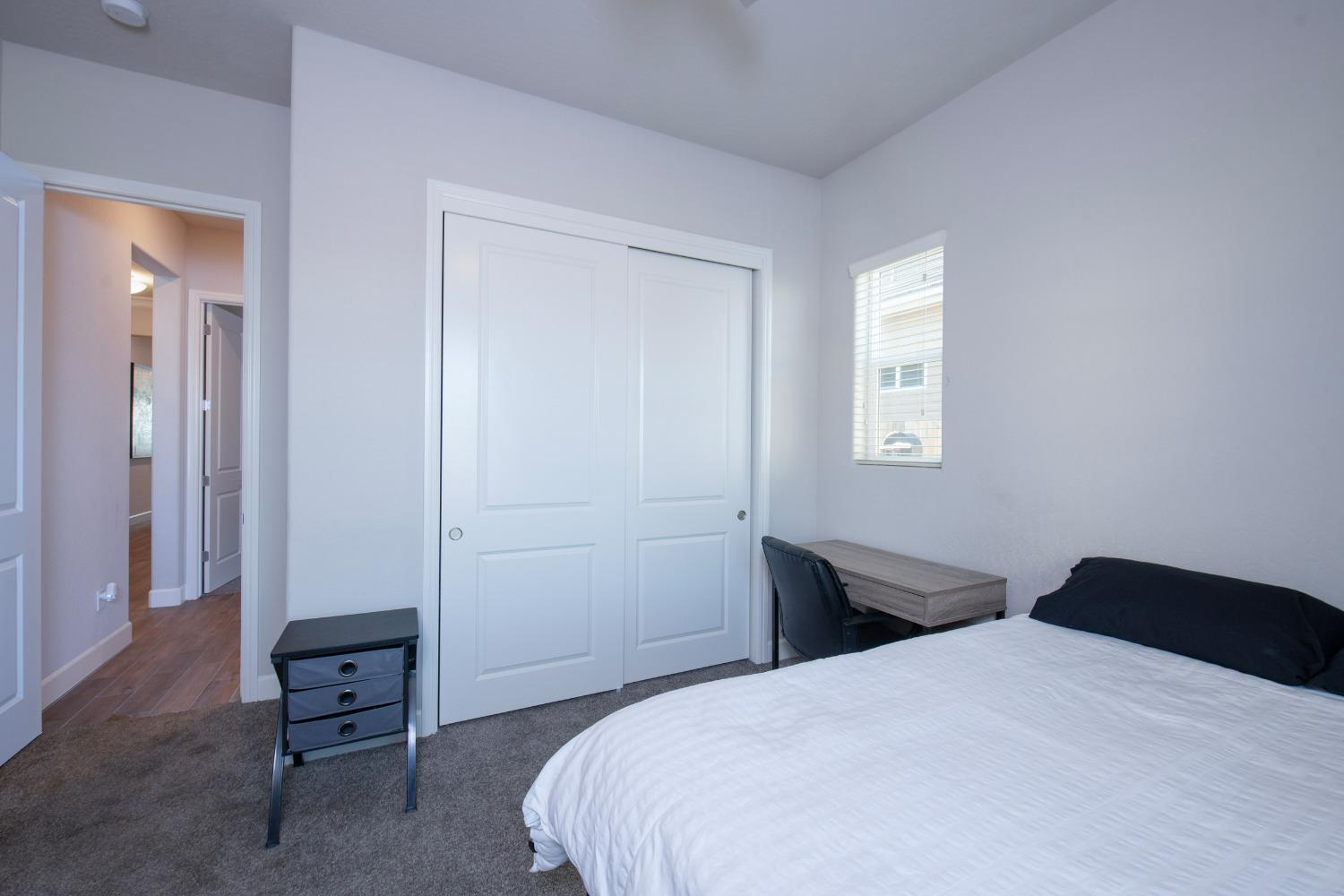 2120 North Perry Avenue Clovis, CA 93619 - Photo 25 of 37 a bedroom with a bed and a window