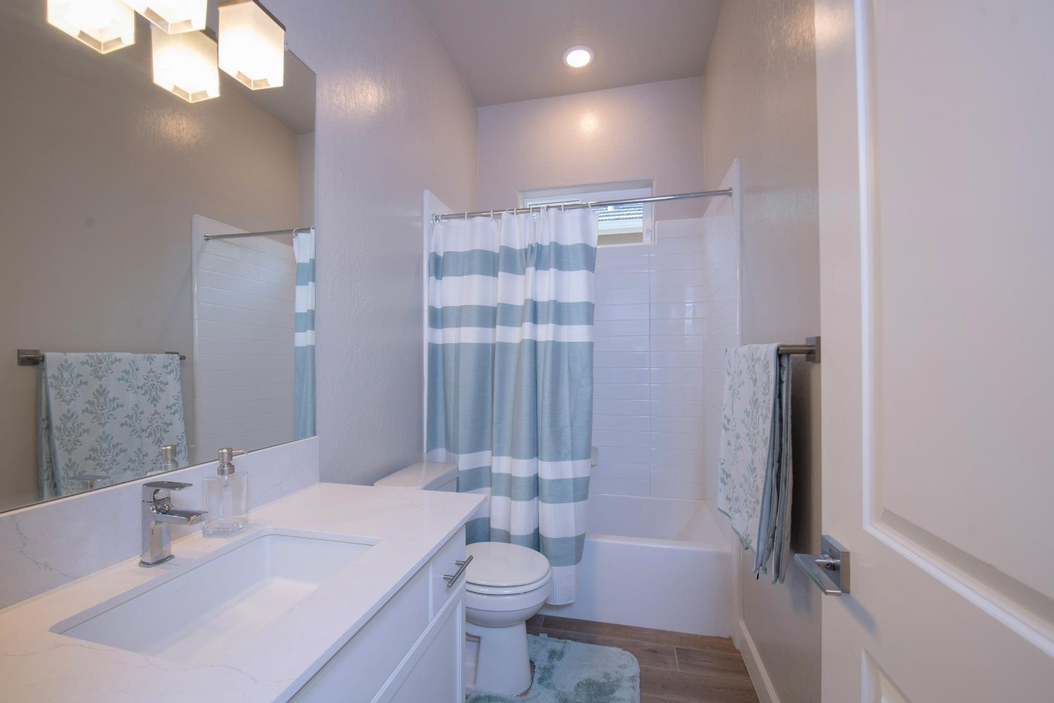2120 North Perry Avenue Clovis, CA 93619 - Photo 26 of 37 a bathroom with a sink a toilet and shower