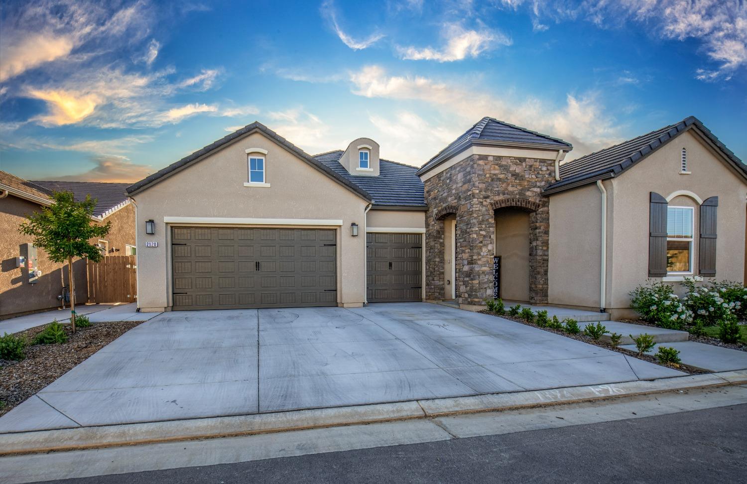 2120 North Perry Avenue Clovis, CA 93619 - Photo 34 of 37 a front view of a house with a yard and garage