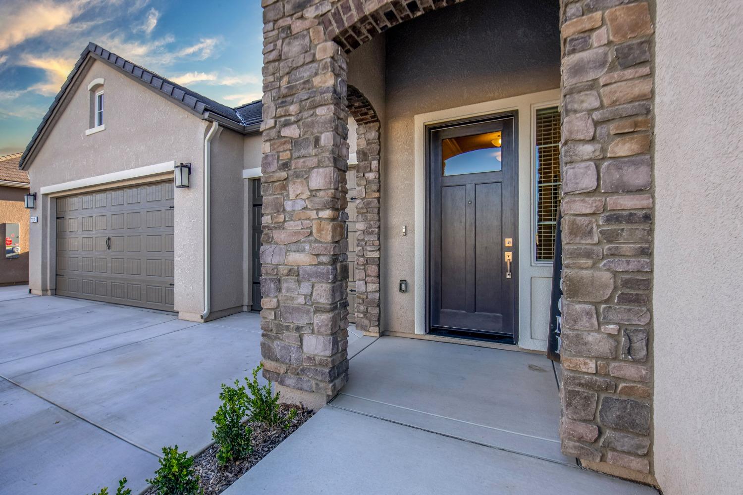 2120 North Perry Avenue Clovis, CA 93619 - Photo 35 of 37 front view of a brick house with a large door