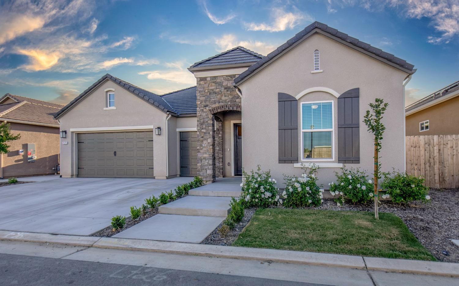 2120 North Perry Avenue Clovis, CA 93619 - Photo 6 of 37 a front view of a house with a yard and garage