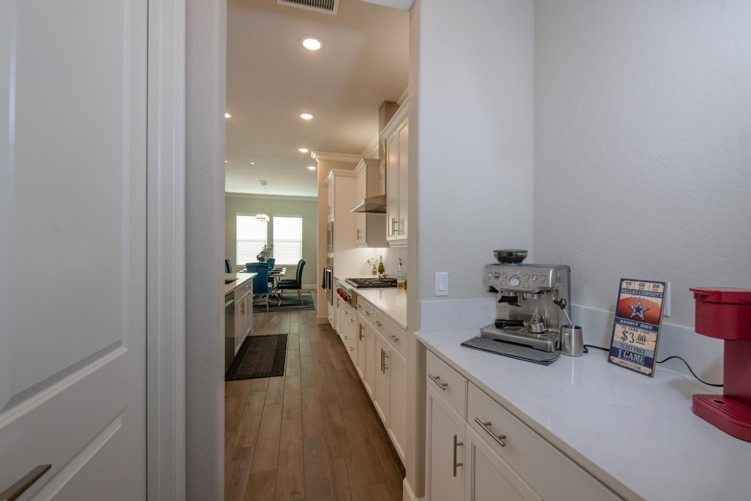 2120 North Perry Avenue Clovis, CA 93619 - Photo 10 of 37 a large white kitchen with sink and cabinets