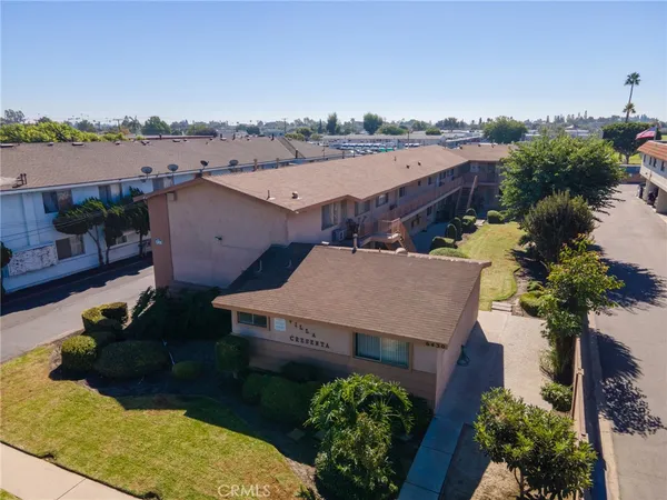 an aerial view of a house with a yard and lake view