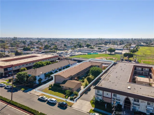 an aerial view of residential houses with yard and ocean view