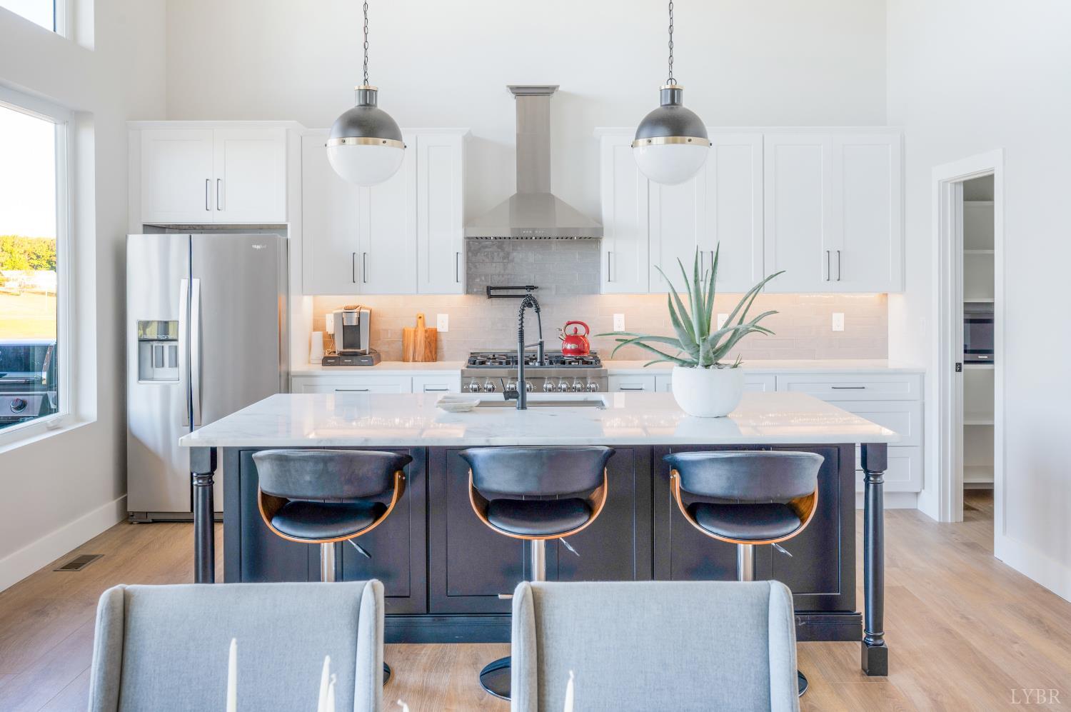 197 Cricket Lane Rustburg, VA 24588 - Photo 12 of 38 a kitchen with a table chairs refrigerator and cabinets