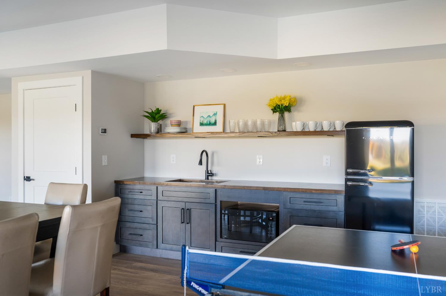 197 Cricket Lane Rustburg, VA 24588 - Photo 28 of 38 a kitchen with stainless steel appliances granite countertop a sink a microwave refrigerator and chairs