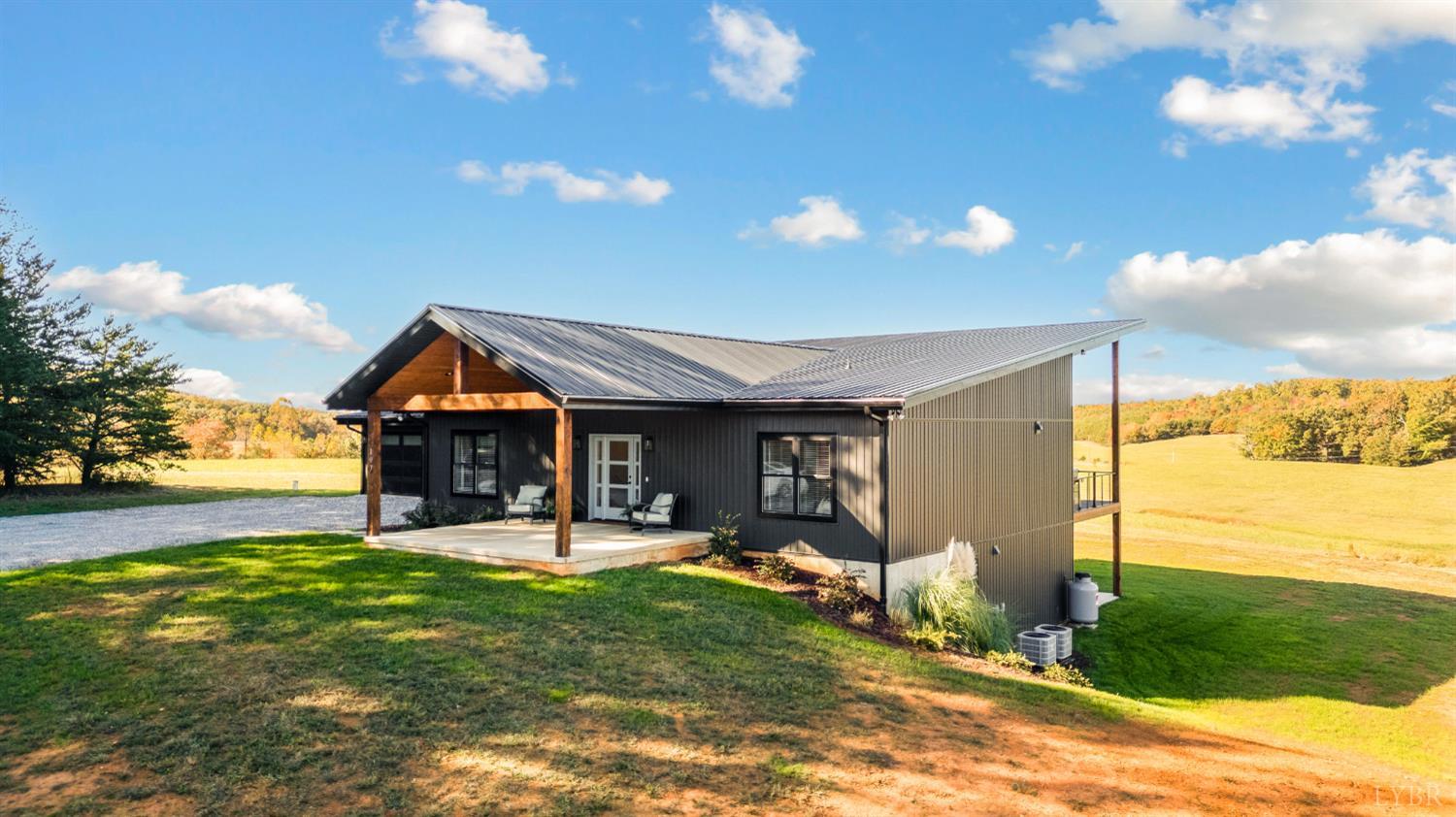 197 Cricket Lane Rustburg, VA 24588 - Photo 3 of 38 a view of a house with a yard patio and sitting area