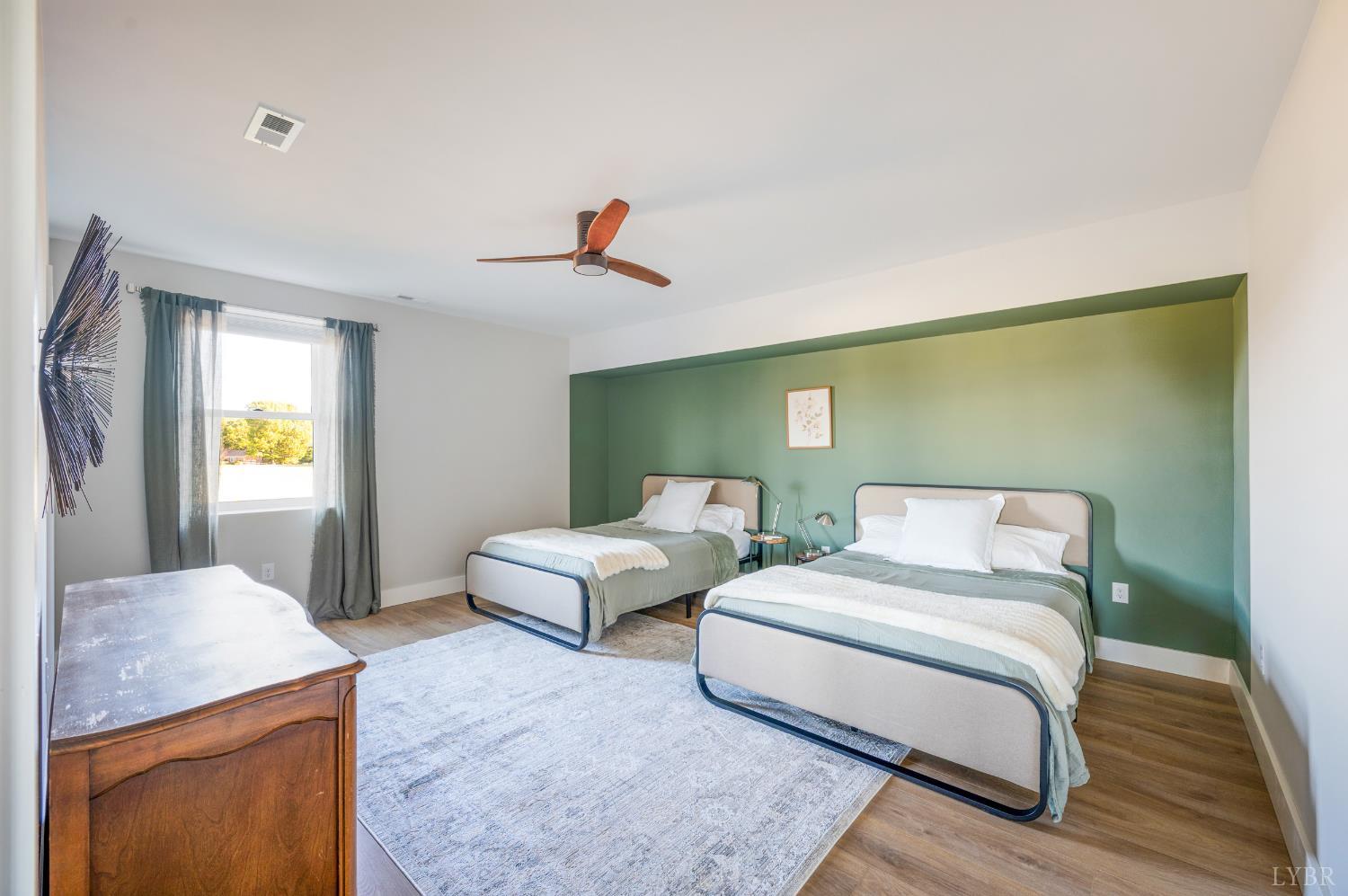 197 Cricket Lane Rustburg, VA 24588 - Photo 32 of 38 a spacious bedroom with two beds and painting on the wall