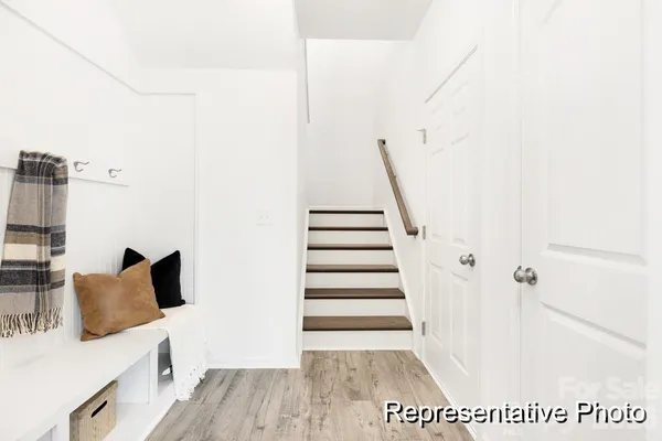 a view of a bedroom with furniture and wooden floor