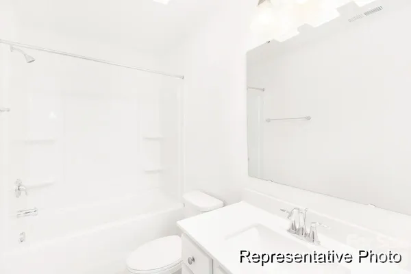 a bathroom with a shower a toilet and a sink