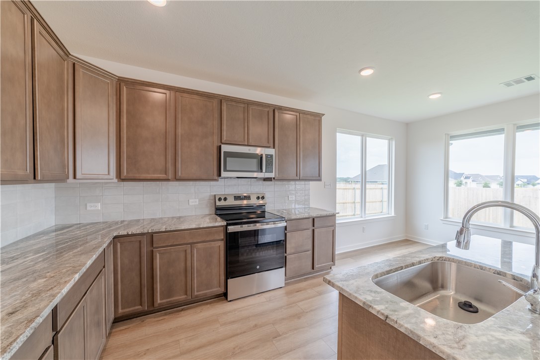 1901 Sebright Drive Bryan, TX 77807 - Photo 3 of 13 a kitchen with a sink stove top oven and refrigerator