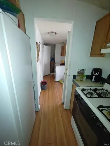a view of a kitchen from a hallway