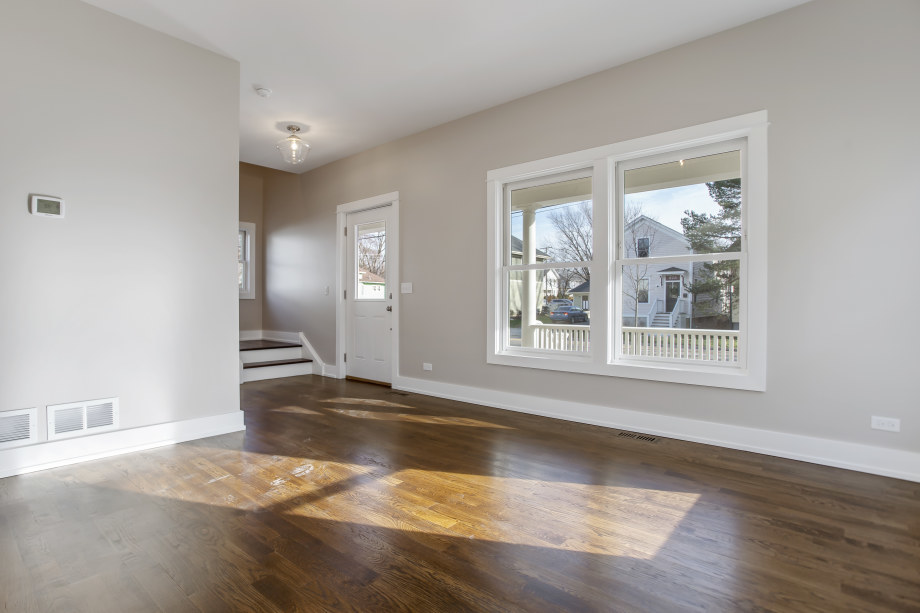 272 North Spring Street Elgin, IL 60120 - Photo 4 of 21 a view of an empty room with wooden floor and a window
