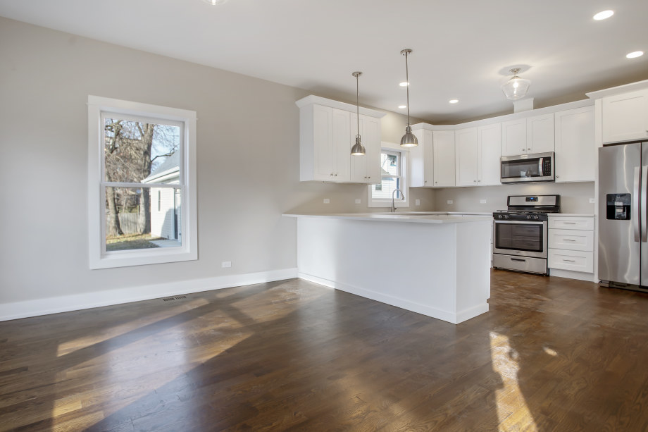 272 North Spring Street Elgin, IL 60120 - Photo 5 of 21 a large kitchen with cabinets and stainless steel appliances