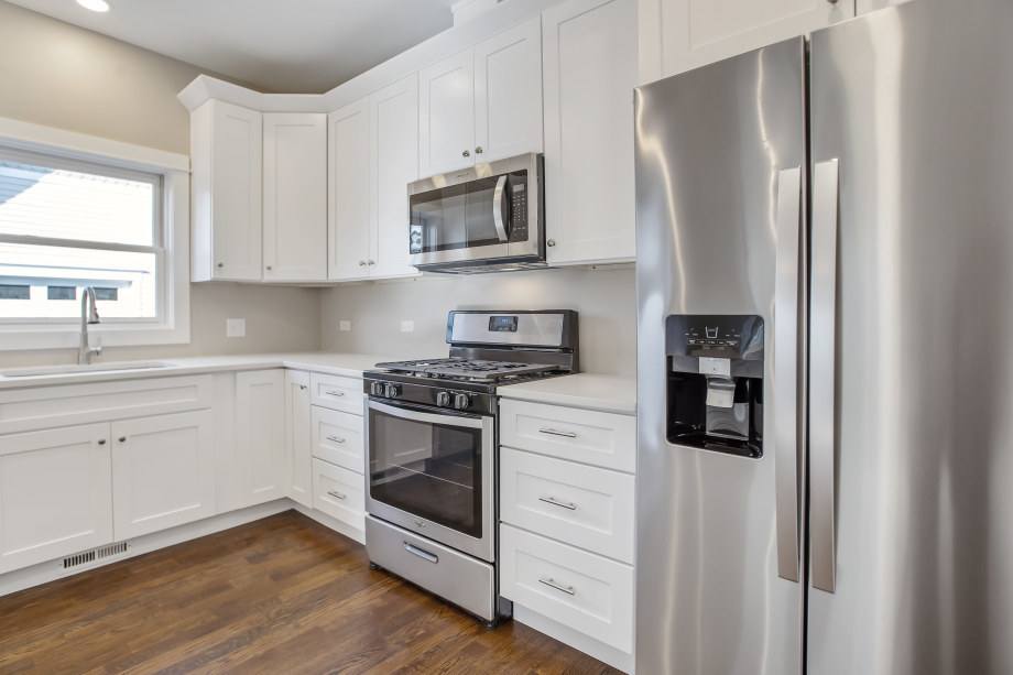 272 North Spring Street Elgin, IL 60120 - Photo 8 of 21 a kitchen with stainless steel appliances white cabinets and a refrigerator