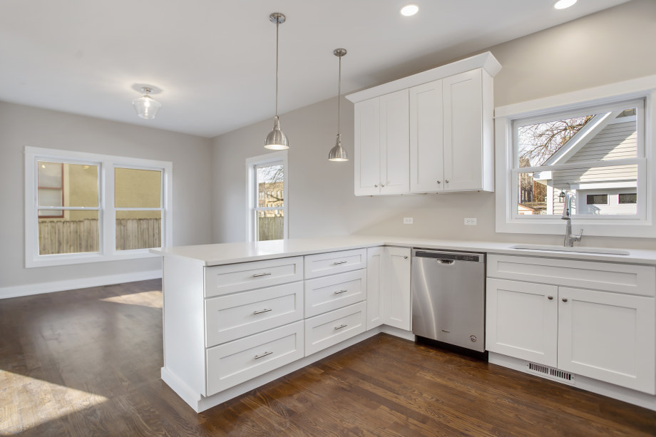 272 North Spring Street Elgin, IL 60120 - Photo 9 of 21 a kitchen with granite countertop white cabinets and window