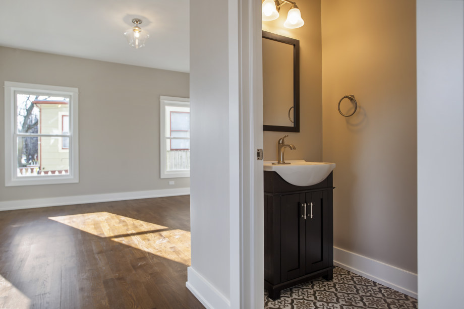 272 North Spring Street Elgin, IL 60120 - Photo 10 of 21 a bathroom with a sink a window and a mirror