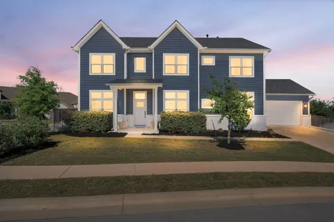 a front view of a house with yard and garage