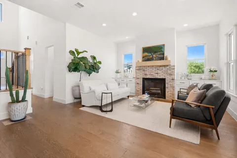 a living room with furniture potted plant and a fireplace