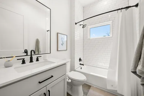 a bedroom with a bed next to a window