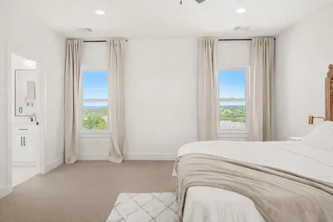 a spacious bedroom with a bed and a window