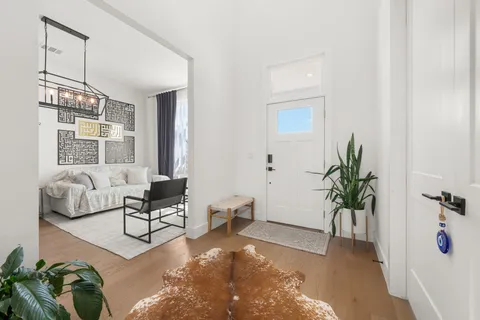 a living room with furniture and a chandelier