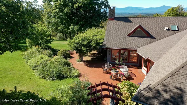an aerial view of house with yard swimming pool and outdoor seating