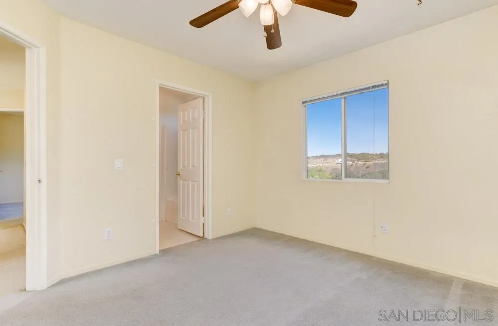 1397 Sunhaven Road Alpine, CA 91901 - Photo 22 of 26 an empty room with a chandelier fan