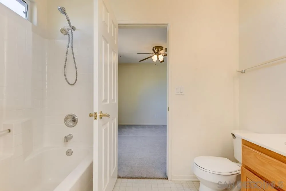 1397 Sunhaven Road Alpine, CA 91901 - Photo 23 of 26 a bathroom with a granite countertop toilet and a shower