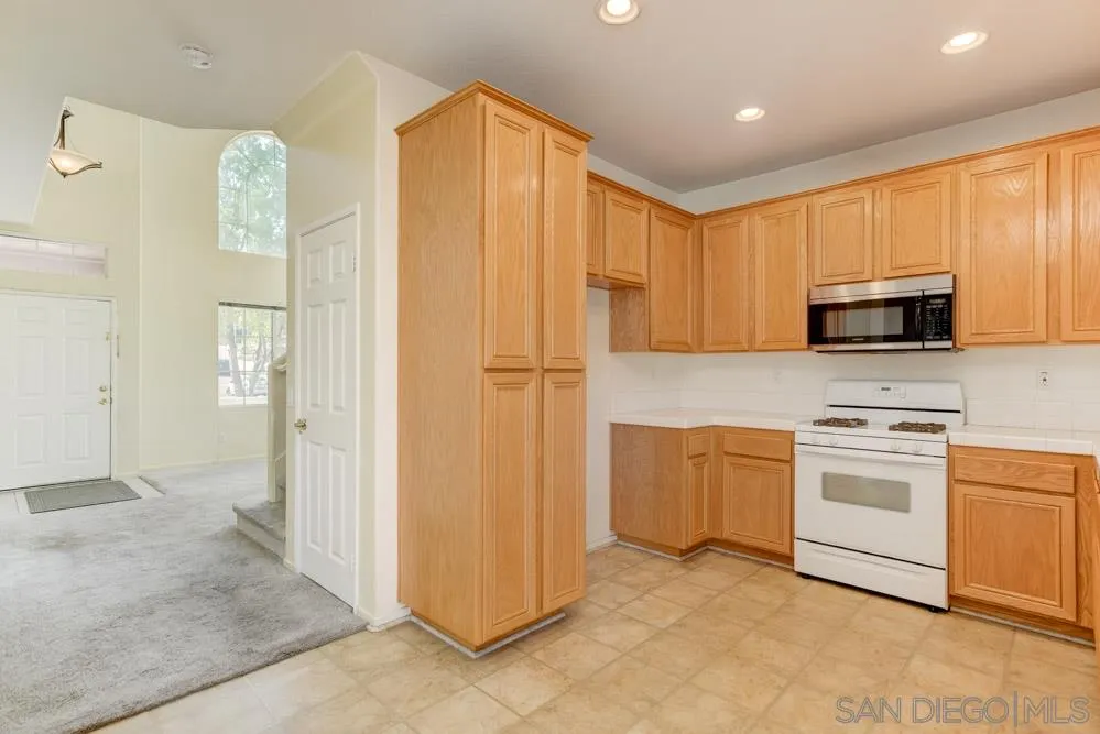 1397 Sunhaven Road Alpine, CA 91901 - Photo 4 of 26 a kitchen with stainless steel appliances granite countertop a refrigerator a stove top oven a sink and dishwasher
