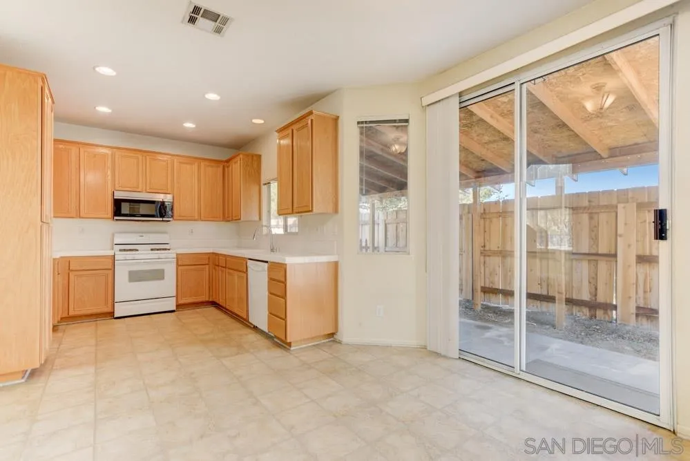 1397 Sunhaven Road Alpine, CA 91901 - Photo 7 of 26 a kitchen with stainless steel appliances granite countertop a stove a sink and a refrigerator