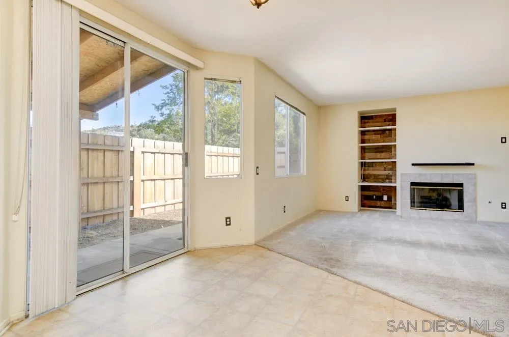 1397 Sunhaven Road Alpine, CA 91901 - Photo 8 of 26 an empty room with windows and fireplace