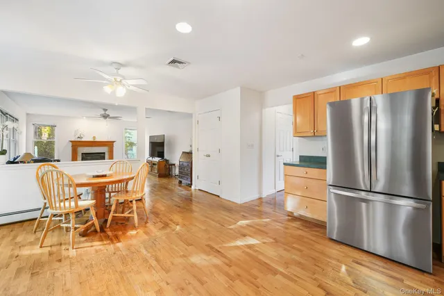 a view of a dining room with furniture a rug a chandelier and wooden floor