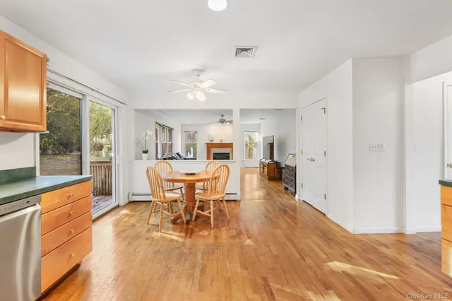 a dining room with furniture a chandelier and wooden floor