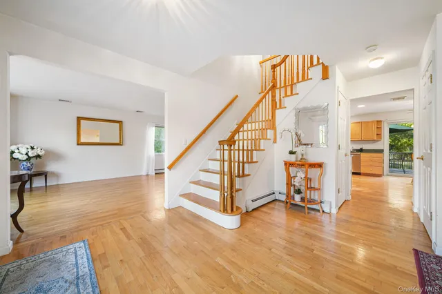 a view of entryway and hall with wooden floor