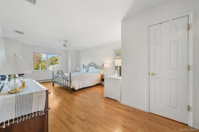 a bedroom with furniture and a wooden floor